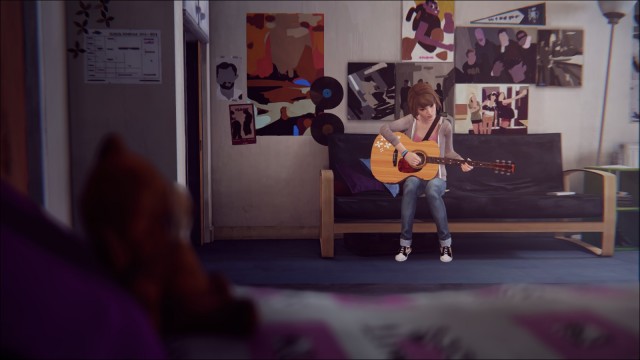 Max playing a guitar